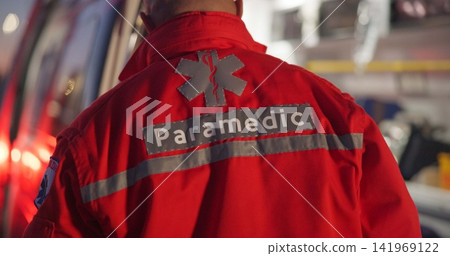 Back, man and paramedic walking to ambulance for emergency, ems service and healthcare in city. Rear view, medical professional and doctor outdoor at night for first aid, rescue operation and work Back, man and paramedic walking to ambulance for emergency, ems service and healthcare in city. Rear view, medical professional and doctor outdoor at night for first aid, rescue operation and work 141969122