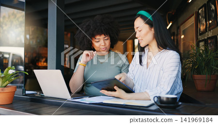 Cafe, coworkers and tablet with laptop, remote work and conversation for job, online and internet. Women, project and explaining for freelance career, copywriters or working on social media campaign Cafe, coworkers and tablet with laptop, remote work and conversation for job, online and internet. Women, project and explaining for freelance career, copywriters or working on social media campaign 141969184