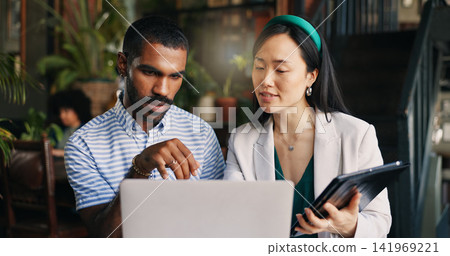 Business people, laptop and tablet at cafe for research, schedule planning or design in creative startup. Happy man and woman working with technology on project, brainstorming or ideas at coffee shop Business people, laptop and tablet at cafe for research, schedule planning or design in creative startup. Happy man and woman working with technology on project, brainstorming or ideas at coffee shop 141969221