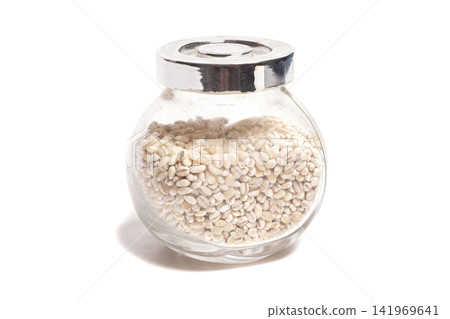pearl barley in a jar isolated on white. pearl barley in a jar isolated on white. 141969641