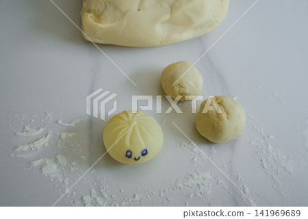 Dumpling Squishy Toy with Dough Pieces on White Background Dumpling Squishy Toy with Dough Pieces on White Background 141969689