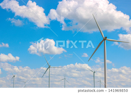 Wind turbine farm producing renewable energy in rural landscape 141969850