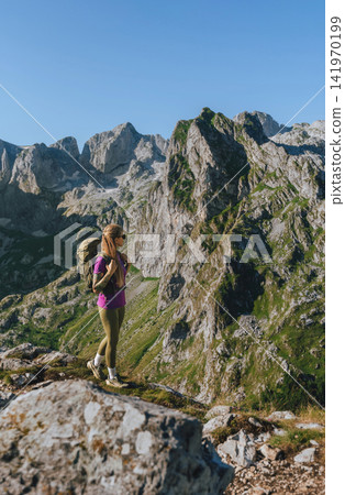 Woman Hiker with Backpack Enjoying Slow Travel Woman Hiker with Backpack Enjoying Slow Travel 141970199