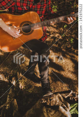 Closeup of Musician Hands Playing Acoustic Guitar Closeup of Musician Hands Playing Acoustic Guitar 141970222