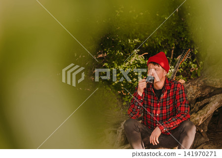 Man Drinking Coffee at Forest Camp Man Drinking Coffee at Forest Camp 141970271