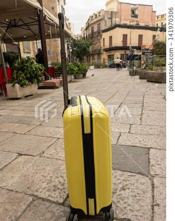 Traveling in spring with a yellow suitcase in Europe, walking in Italy, Palermo Traveling in spring with a yellow suitcase in Europe, walking in Italy, Palermo 141970306