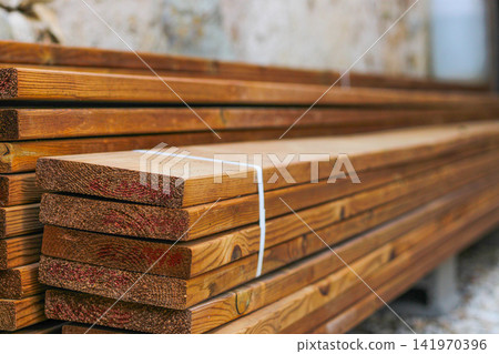 Stack of brown wooden planks, floor construction planks Stack of brown wooden planks, floor construction planks 141970396