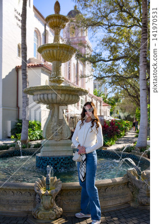 Woman Posing In Front Of Tiered Fountain Woman Posing In Front Of Tiered Fountain 141970531