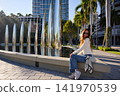 Woman Sitting Near Sculptural Art Installation 141970539