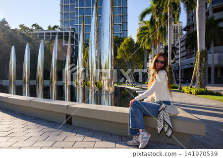 Woman Sitting Near Sculptural Art Installation Woman Sitting Near Sculptural Art Installation 141970539