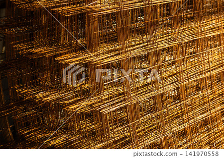 Close-up of Stacked Rusty Metal Mesh Panels 141970558