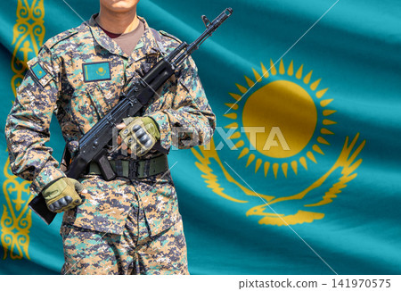 Kazakhstan flag with soldier holding assault rifle Kazakhstan flag with soldier holding assault rifle 141970575