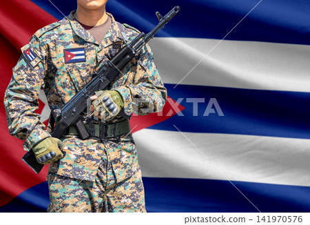 Cuba flag with soldier holding assault rifle Cuba flag with soldier holding assault rifle 141970576