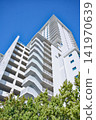 Tall White Residential Tower With Zigzag Balconies 141970639