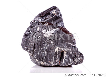 macro mineral stone sherle, schorl, black tourmaline on white background macro mineral stone sherle, schorl, black tourmaline on white background 141970732