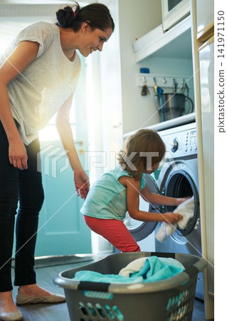 Help, laundry and mom with kid in home for chores, teaching and learning housekeeping routine. Washing machine, mother and daughter cleaning clothes together with support, care and child development. Help, laundry and mom with kid in home for chores, teaching and learning housekeeping routine. Washing machine, mother and daughter cleaning clothes together with support, care and child development. 141971150