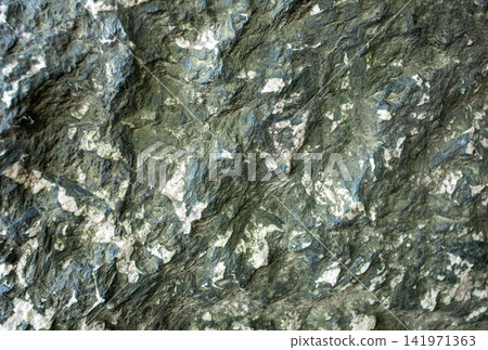 Close up view of textured surface of serpentinite or serpentine with mineral patterns and colors Close up view of textured surface of serpentinite or serpentine with mineral patterns and colors 141971363