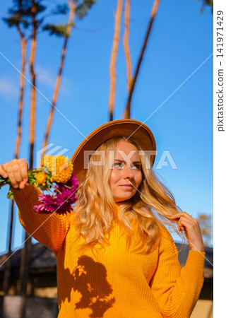 Woman faceless yellow sweater showing into camera Autumn Fall Bouquet for Thanksgiving holiday. Seasonal Warm colorful blossom flowers arrangement festive decoration Woman faceless yellow sweater showing into camera Autumn Fall Bouquet for Thanksgiving holiday. Seasonal Warm colorful blossom flowers arrangement festive decoration 141971429