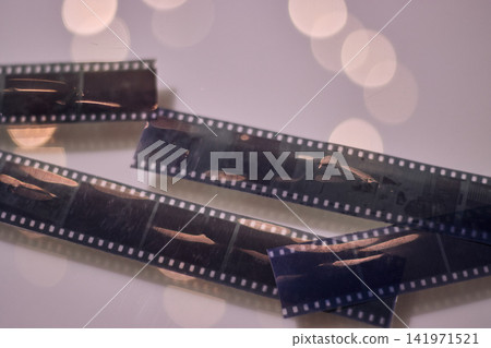 View of photographic rolls showing some of their scenes, with dim lighting, and in good condition. Displayed to the public. Analog, vintage, retro photography. 141971521
