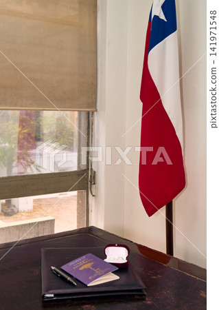 The couple's rings, along with the civil union documents, highlighting the Chilean flag, await the newlyweds on their wedding day. The couple's rings, along with the civil union documents, highlighting the Chilean flag, await the newlyweds on their wedding day. 141971548
