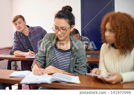 College student, man and copying test in classroom with reading, question paper and answers at campus. Person, cheating and writing exam with women, info and assessment for education at university College student, man and copying test in classroom with reading, question paper and answers at campus. Person, cheating and writing exam with women, info and assessment for education at university 141972099