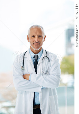 Doctor, confidence and portrait of mature man in a hospital at cardiology clinic with arms crossed. Professional, medical employee and stethoscope with healthcare, job and cardiologist consultant Doctor, confidence and portrait of mature man in a hospital at cardiology clinic with arms crossed. Professional, medical employee and stethoscope with healthcare, job and cardiologist consultant 141972116