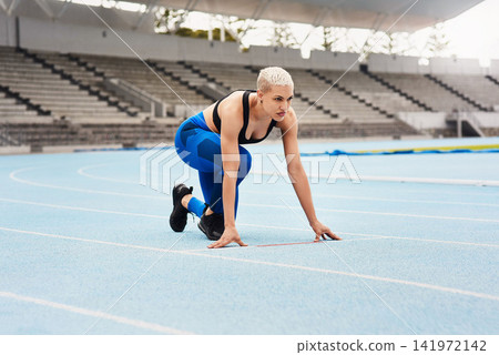 Woman, runner and start for sports, exercise and warm up in stadium or field for fitness. Female athlete, training and track in outdoor for wellness, performance and strong in cardio, body and mind Woman, runner and start for sports, exercise and warm up in stadium or field for fitness. Female athlete, training and track in outdoor for wellness, performance and strong in cardio, body and mind 141972142