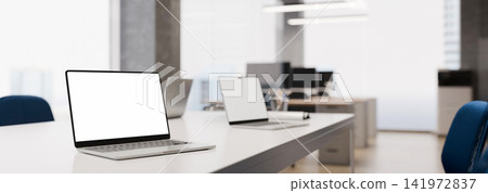 3D Render of Modern Office Workspace with Laptops on White Desk and Blank Screens for Mockup 3D Render of Modern Office Workspace with Laptops on White Desk and Blank Screens for Mockup 141972837