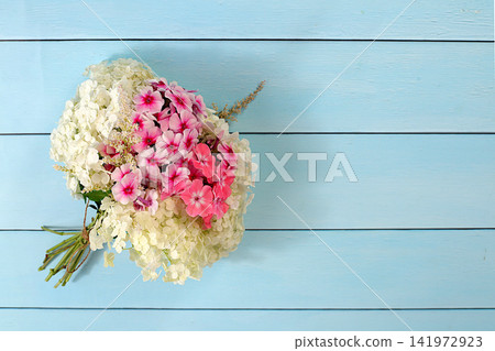 Bouquet of various varieties of phlox and garden hydrangea on a bright sunny background, an advertising banner for summer and autumn products, an abstract floral arrangement, a flat lay still life, Bouquet of various varieties of phlox and garden hydrangea on a bright sunny background, an advertising banner for summer and autumn products, an abstract floral arrangement, a flat lay still life, 141972923