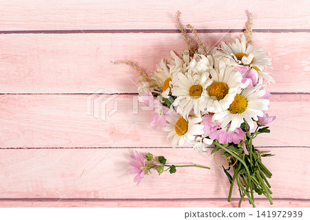 Bouquet of white daisies and mallow on wooden background, summer and autumn product advertising banner, abstract floral arrangement, flat lay still life, autumn holiday card with space for text 141972939