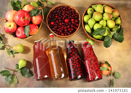 Apples, pears and cherries in baskets with bottles of cider, compote, and mulled wine, a Thanksgiving backdrop and a rustic harvest, concept of healthy natural food and home canning, Apples, pears and cherries in baskets with bottles of cider, compote, and mulled wine, a Thanksgiving backdrop and a rustic harvest, concept of healthy natural food and home canning, 141973181