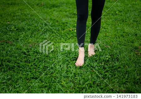 Close up Barefoot Grounding on Green Grass Woman Practicing Earthing for Wellness and Natural Healing Close up Barefoot Grounding on Green Grass Woman Practicing Earthing for Wellness and Natural Healing 141973183