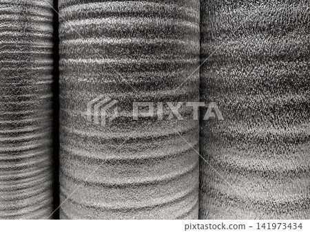 Silver rolls of insulation material, building materials in a hardware store Silver rolls of insulation material, building materials in a hardware store 141973434
