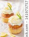 Lemon cupcakes with cream frosting and fresh lemons 141973757