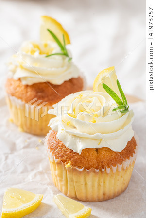 Lemon cupcakes with cream frosting and fresh lemons 141973757