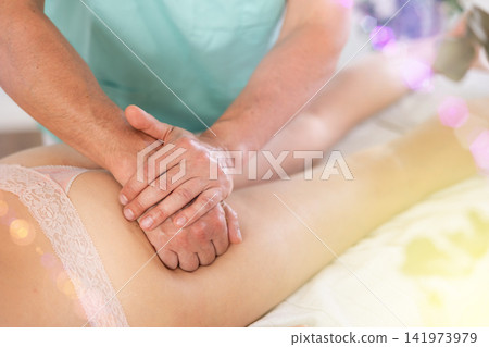 massage therapist doing a massage massage therapist doing a massage 141973979