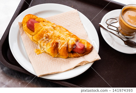 Croissant with sausage served with coffee Croissant with sausage served with coffee 141974393