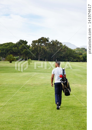 Sports, man and walking on golf course with bag or athlete outdoor on luxury holiday or vacation. Grass, field and exercise in summer on lawn with person in countryside for training or workout Sports, man and walking on golf course with bag or athlete outdoor on luxury holiday or vacation. Grass, field and exercise in summer on lawn with person in countryside for training or workout 141974617
