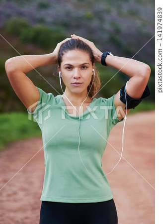 Fitness, portrait and woman tired on run and breathing to rest with music in headphones in exercise or workout. Athlete, break and girl training in summer with resilience for challenge in countryside Fitness, portrait and woman tired on run and breathing to rest with music in headphones in exercise or workout. Athlete, break and girl training in summer with resilience for challenge in countryside 141974839