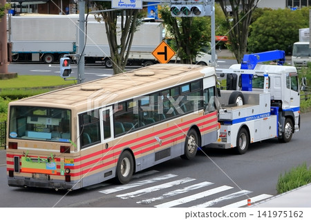 Image of a large bus being towed away. Image of a large bus being towed away. 141975162