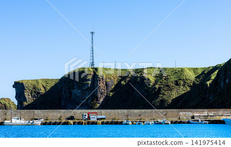 Cape Ochishi as seen from Ochishi Fishing Port in Nemuro City, Hokkaido, on a clear day. Cape Ochishi as seen from Ochishi Fishing Port in Nemuro City, Hokkaido, on a clear day. 141975414
