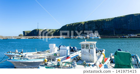 Cape Ochishi as seen from Ochishi Fishing Port in Nemuro City, Hokkaido, on a clear day. Cape Ochishi as seen from Ochishi Fishing Port in Nemuro City, Hokkaido, on a clear day. 141975415