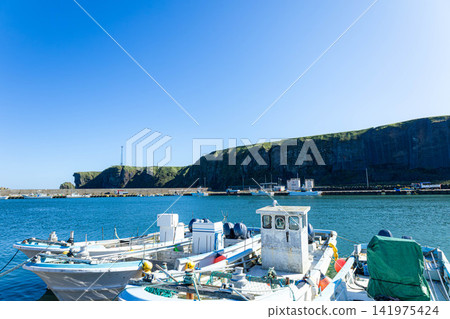 Cape Ochishi as seen from Ochishi Fishing Port in Nemuro City, Hokkaido, on a clear day. Cape Ochishi as seen from Ochishi Fishing Port in Nemuro City, Hokkaido, on a clear day. 141975424