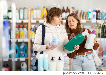 Two women choosing laundry detergent in department store Two women choosing laundry detergent in department store 141975647