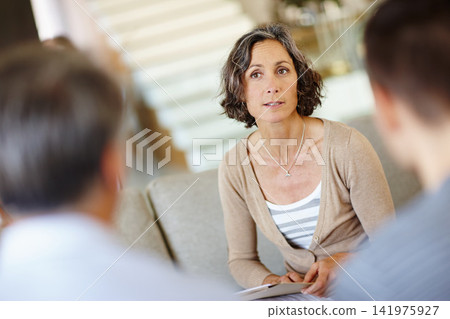 Female therapist, people and meeting on sofa for mental health, therapy and consultation. Mature advisor, family and discussion on couch with notes for advice, session and listening or wellness Female therapist, people and meeting on sofa for mental health, therapy and consultation. Mature advisor, family and discussion on couch with notes for advice, session and listening or wellness 141975927