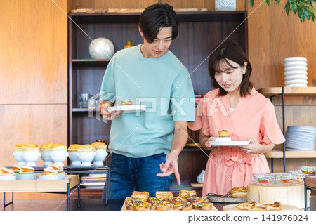 A young couple choosing their meal A young couple choosing their meal 141976024