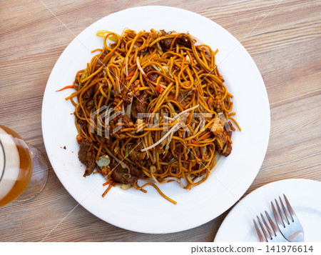 Chinese fried beef noodles served on platter Chinese fried beef noodles served on platter 141976614