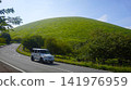 An off-road SUV (Mercedes) driving on a road near Mt. Omuro (Izu Kogen) in summer. 141976959