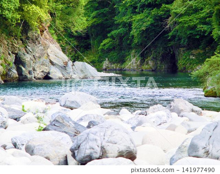 A landscape of a stream gently flowing over rocky terrain. A landscape of a stream gently flowing over rocky terrain. 141977490
