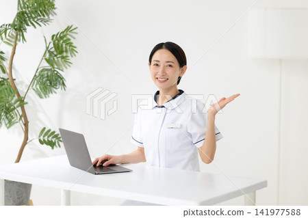 Woman in a white coat at a beauty clinic Woman in a white coat at a beauty clinic 141977588